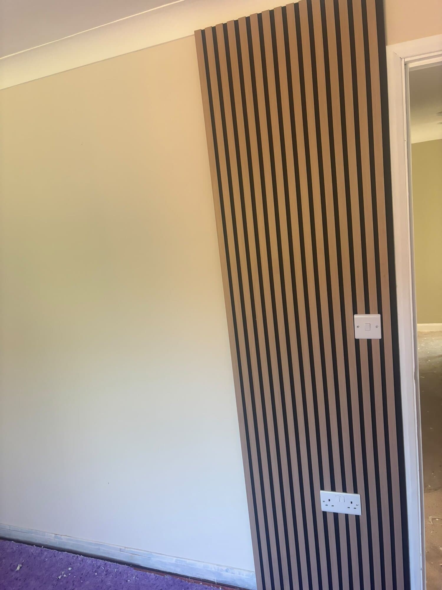 Oak slat feature wall with sockets and switch set in flush